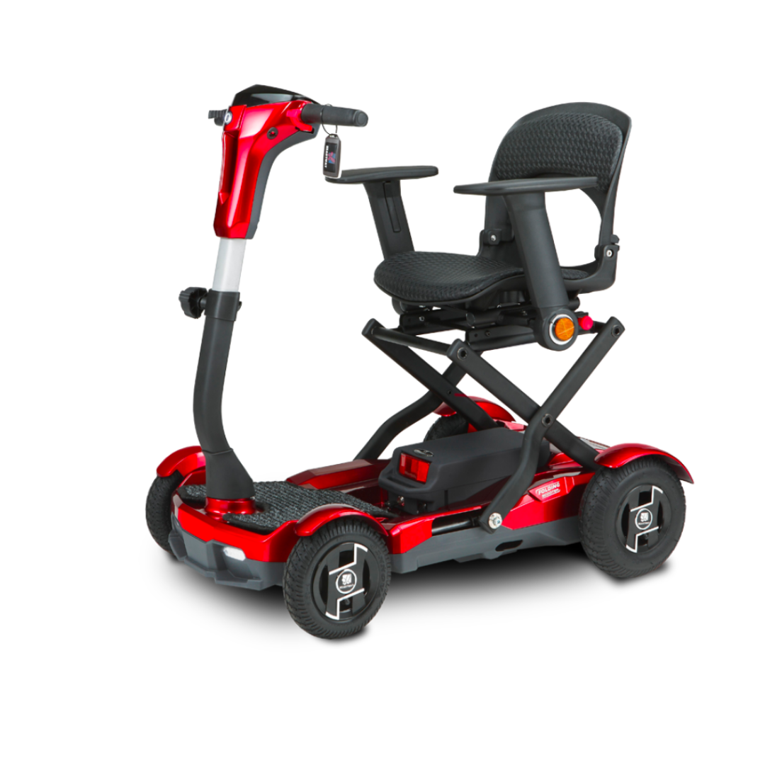 The EV Rider Teqno Automatic Folding Portable Travel Scooter is a red and black mobility scooter with a padded seat, armrests, compact design, raised seat mechanism, and handlebar controls.